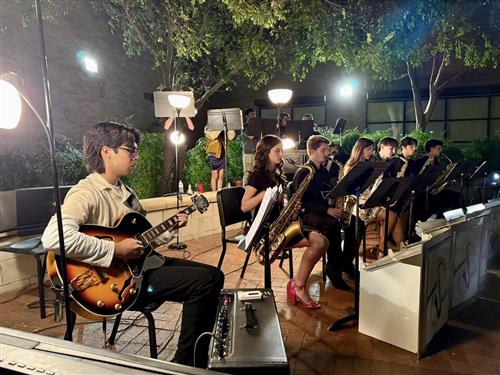 A jazz band performs at night outside